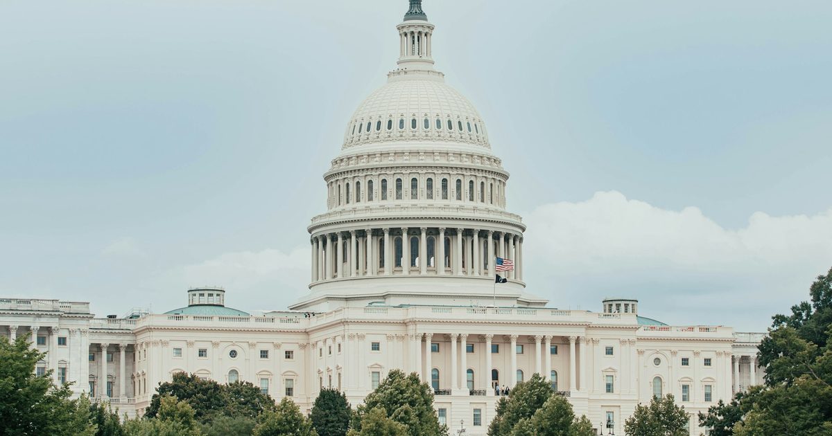 A government capitol building with a dome, seen across water — representing AI legislation
