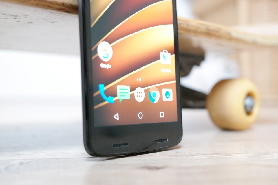 An Android phone propped upright showing app icons on its home screen