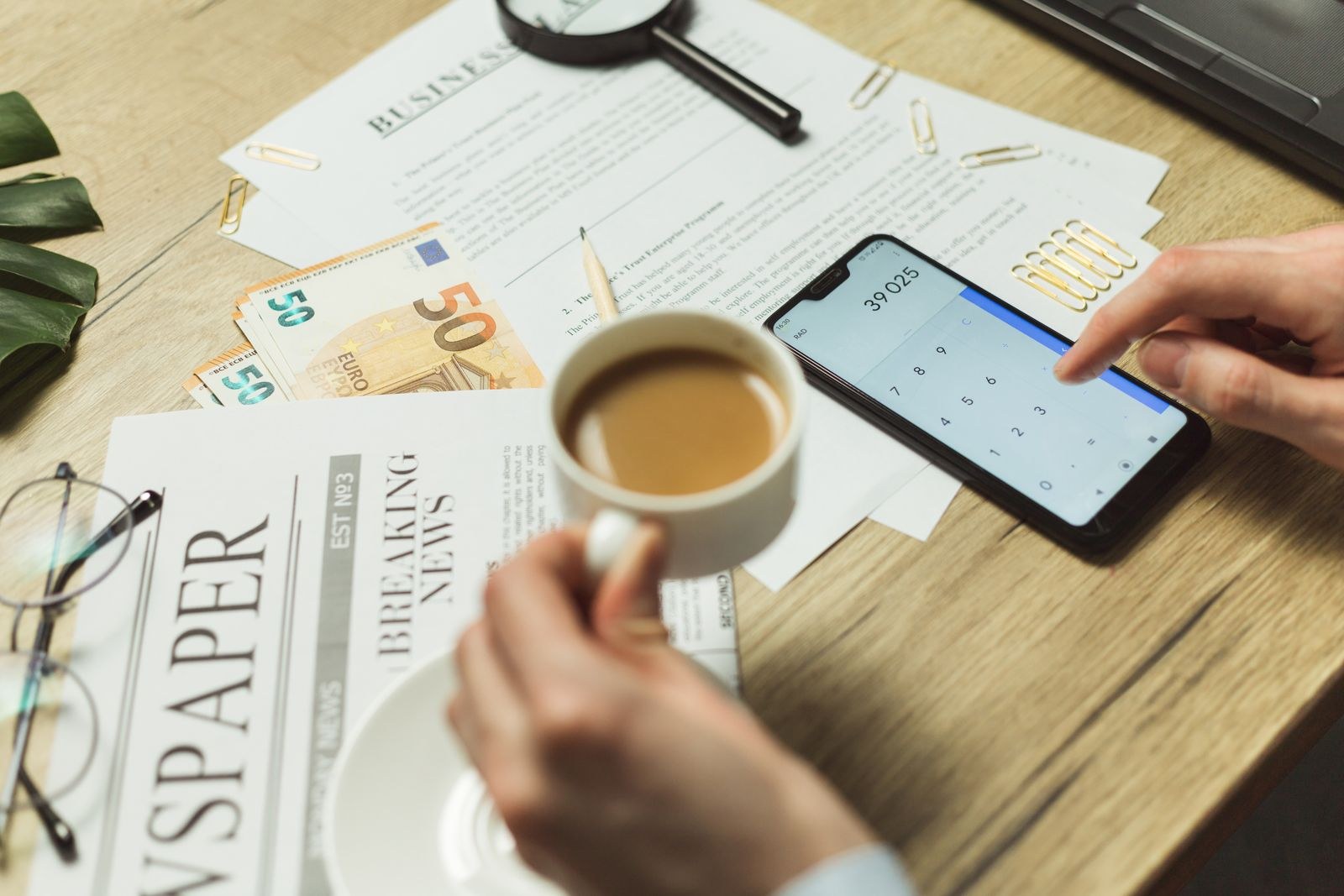 A workspace with paper documents and a phone from above