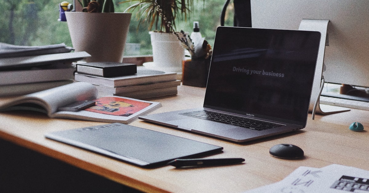 MacBook Pro laptop on a clean desk, representing focused workspace and undistracted work
