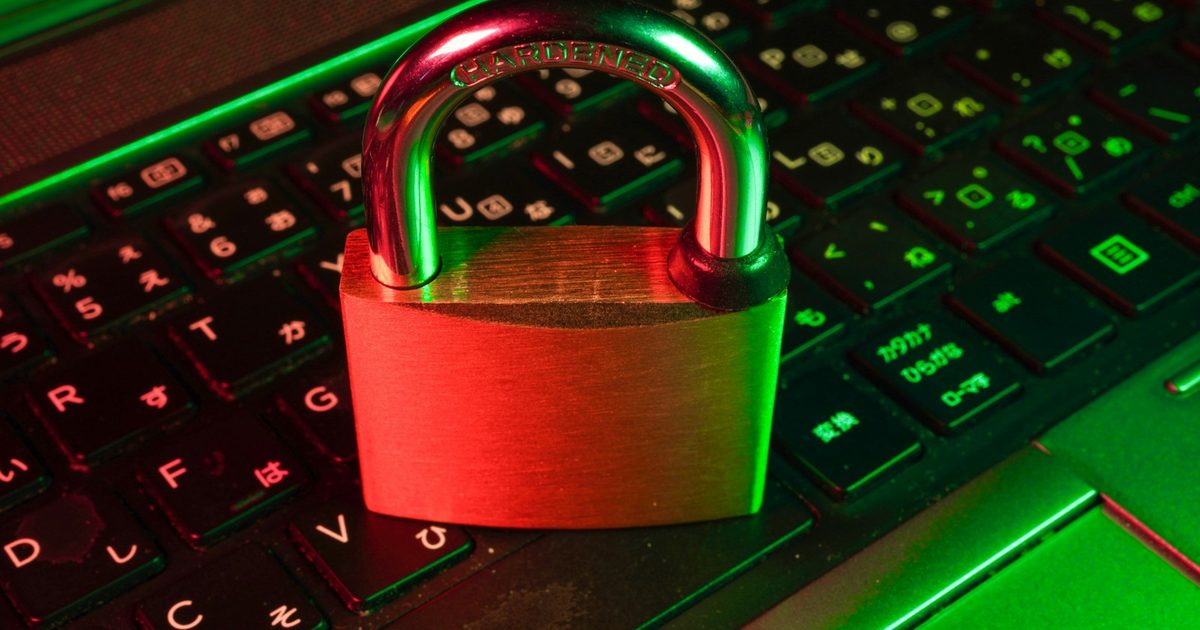 A red padlock resting on a black computer keyboard