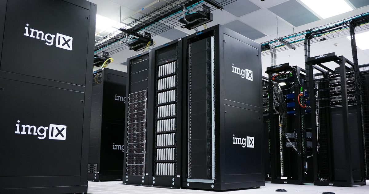 Rows of servers in a clean white data center, representing cloud storage