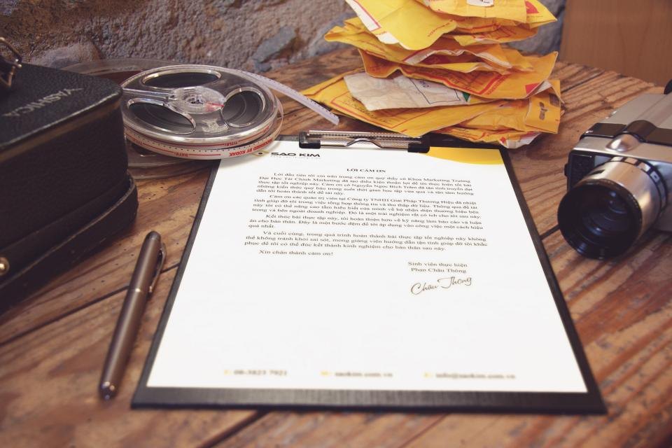 A printed letter on a clipboard with a pen beside it