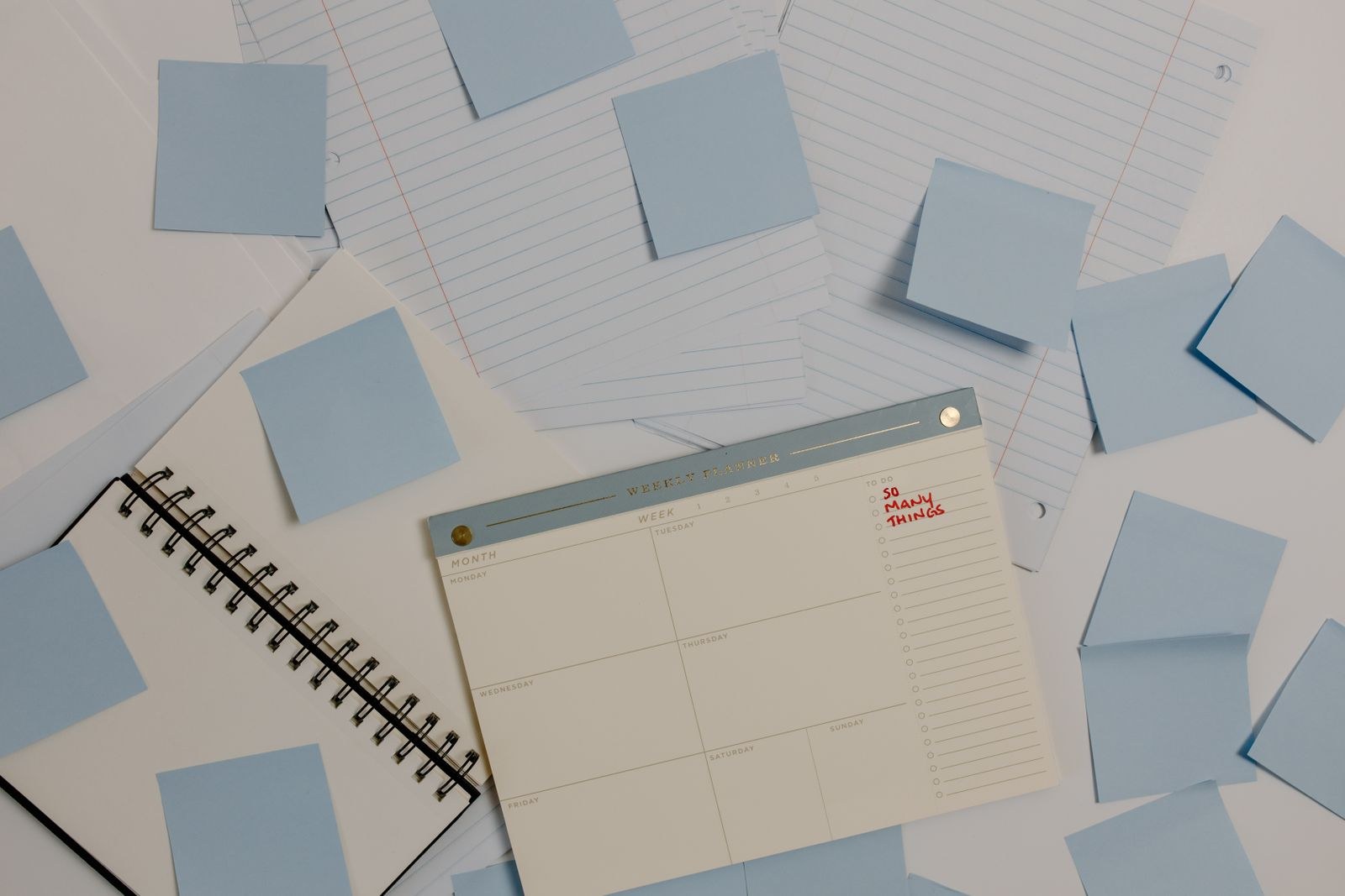 An organized desk with a planner and sticky notes, representing a clear content system