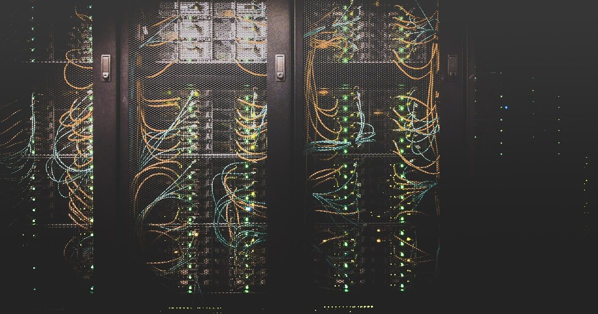 Rows of network cabling and servers inside a data center
