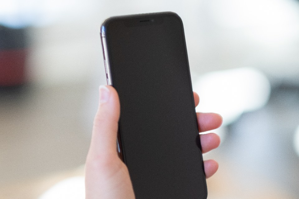 A hand holding a smartphone